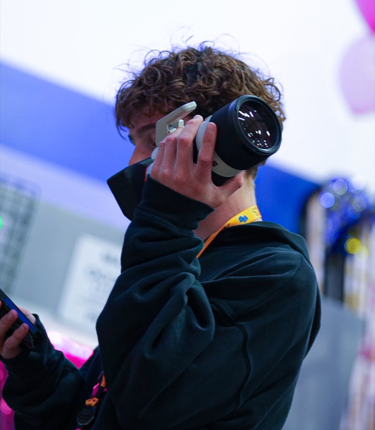 Hudson lifting a telephoto lens to his eye