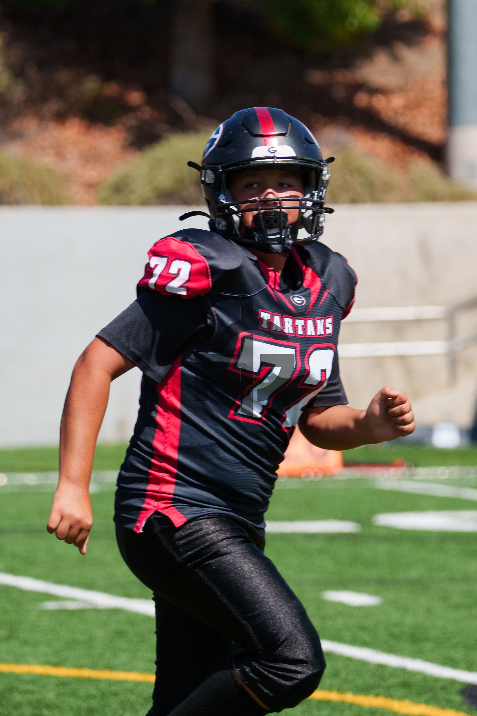 A lineman in a black jersey approaches the camera